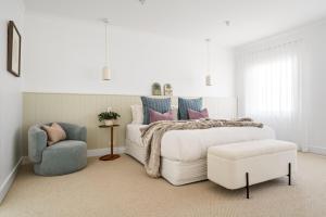 a white bedroom with a bed and a chair at The View, Albany Holiday House in Albany +29 photos