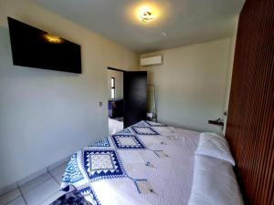 a bedroom with a bed and a television on the wall at Vista Sumidero in Tuxtla Gutiérrez