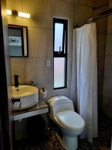 a bathroom with a white toilet and a sink at Vista Sumidero in Tuxtla Gutiérrez +16 photos