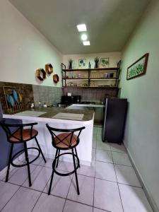 a kitchen with two chairs and a counter in a room at Vista Sumidero in Tuxtla Gutiérrez