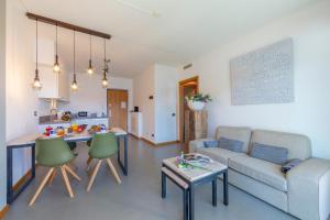 a living room with a couch and a table at Residence degli Oleandri 2A in Argegno