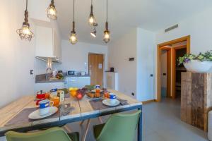 a kitchen with a wooden table with fruit on it at Residence degli Oleandri 2A in Argegno