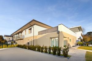 a white house with a roof at Luxea Guest House - B&B Treviso in Preganziol
