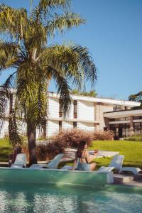 a woman sitting on a boat in a pool at Tramonto hotel & ristorante in Empedrado