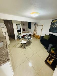 a living room with a couch and a table at לרניקה - יחידות אירוח in Qiryat Shemona