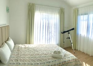 a bedroom with a bed with a camera on a tripod at AAA plus in Nordeste