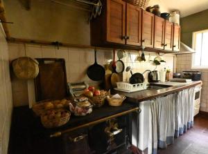 a kitchen with a counter with baskets of fruit on it at Casa Amaranta in La Cumbre +3 photos