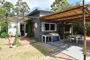 a backyard with a table and a pergola at Casa Amaranta in La Cumbre
