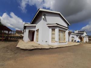 a house is being built on a street at Abodes at 113 in Manzini