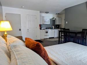 a living room with a couch and a kitchen at Scotty's Motel in Munising
