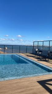 a swimming pool on the roof of a building at LUXER VIVO Encarnacion in Encarnación