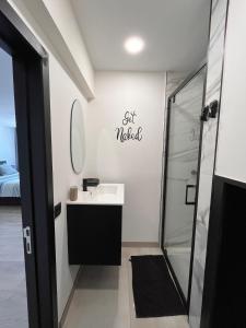 a bathroom with a sink and a shower at Studio moderne et confort - Guillemins in Liège