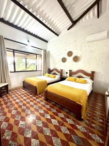 a bedroom with two beds in a room at Finca Hotel Buenos Aires in Guamal +35 photos