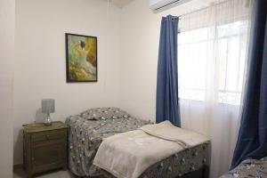 a bedroom with a bed and a dresser and a window at Entire accommodation in Bahia de la Paz in La Paz