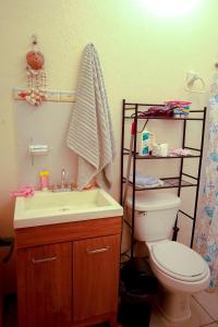 a bathroom with a toilet and a sink at Entire accommodation in Bahia de la Paz in La Paz +33 photos
