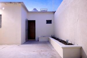 a white building with a door in the side of it at Entire accommodation in Bahia de la Paz in La Paz