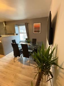 a dining room with a table and chairs at Elegance apartments in West Cornforth +20 photos