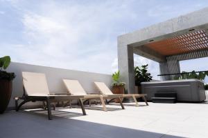 a group of chairs and a table on a patio at Delamar Hotel in San Andrés