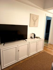a large white entertainment center with a large flat screen tv at SWEET HOME BILBAO in Bilbao