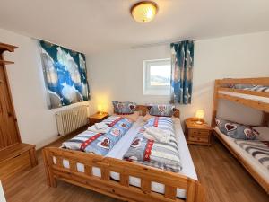 a bedroom with two twin beds and a bunk bed at Ferienhaus Frei 3 Budget in Titisee-Neustadt