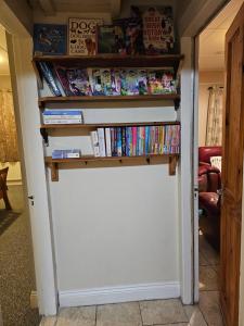 a book shelf over a door with dvds at John's Farmhouse in Kilrush