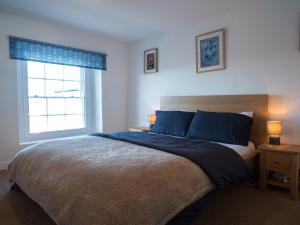a bedroom with a large bed and a window at Harbour View in Aberaeron