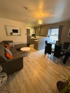 a living room with a couch and a table at Elegance apartments in West Cornforth