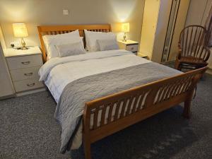 a bedroom with a large bed with two night stands at John's Farmhouse in Kilrush
