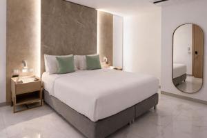 a bedroom with a large bed and a mirror at Delamar Hotel in San Andrés +28 photos