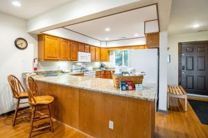 a kitchen with wooden cabinets and a counter top at Mountainside Villas in McGaheysville
