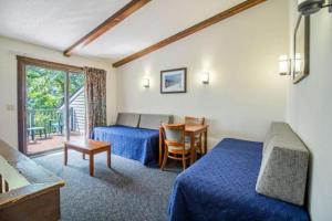 a hotel room with two beds and a table at Mountainside Villas in McGaheysville