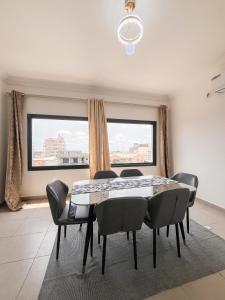 a dining room with a table and chairs at Appart Congo-Warf- vue mer in Pointe-Noire