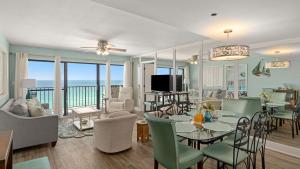a dining room and living room with a view of the ocean at Gull Watch by AvantStay in Panama City Beach