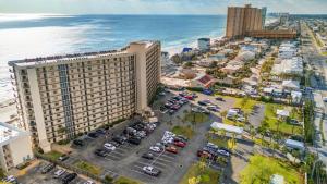 an aerial view of a parking lot in front of the ocean at Gull Watch by AvantStay in Panama City Beach