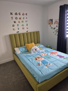 a bedroom with a bed with a blue comforter at The Creek Home in Kemptville