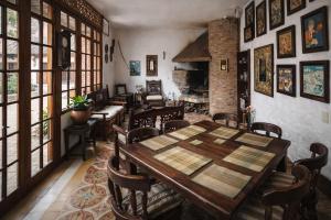 a dining room with a wooden table and chairs at Casona Rosa Lorenza in Corrales +31 photos