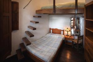 a bedroom with a bed and a desk and bunk beds at Casona Rosa Lorenza in Corrales
