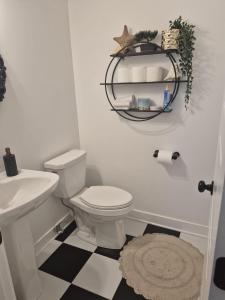 a bathroom with a white toilet and a sink at The Creek Home in Kemptville +20 photos