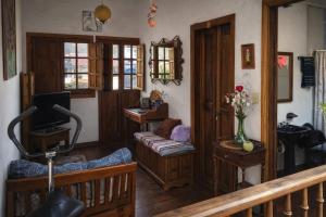 a living room with a couch and a television at Casona Rosa Lorenza in Corrales