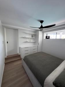 a bedroom with a bed and a ceiling fan at Luxury self-contained guest suite in Gold Coast