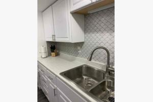 a kitchen with white cabinets and a stainless steel sink at 3Bed 2Bath PRIVATE HOME Decatur in Decatur