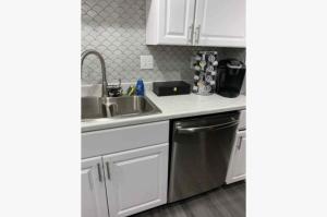a kitchen with white cabinets and a sink and a dishwasher at 3Bed 2Bath PRIVATE HOME Decatur in Decatur