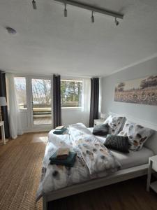 a bedroom with a bed with a blanket on it at Waldfeder Apartment mit Pool und Fitnessraum, neu und vollsaniert in Sankt Englmar +38 photos