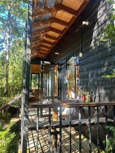 a screened in porch of a house with a deck at Espacio Bosque La Quemada in Puerto Varas