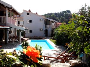 a swimming pool in front of a house at Villas Rab Palit in Rab