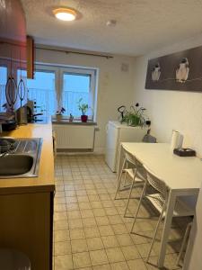 a kitchen with a table and a table and chairs at Nest-Unterkunft in Bad Überkingen