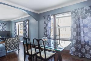 a dining room with a glass table and chairs at College Duplex in Grand Rapids +7 photos