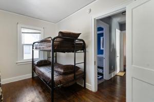 a bedroom with a bunk bed in a room at College Duplex in Grand Rapids
