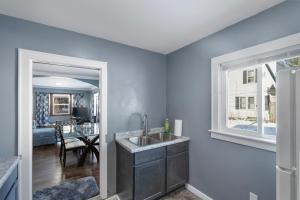 a kitchen with a sink and a window and a table at College Duplex in Grand Rapids