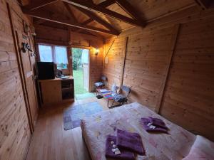 a room with a bed in a wooden cabin at Prague Retro Challenge and Garden in Prague